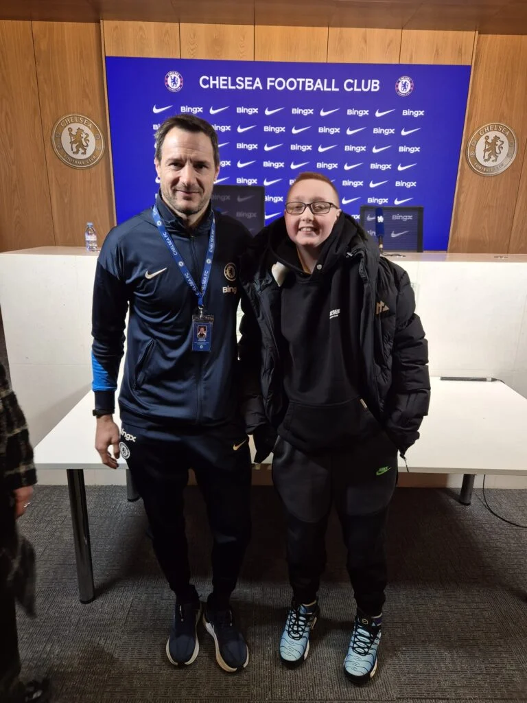 Young fan photographed with a coach in the Chelsea press conference room